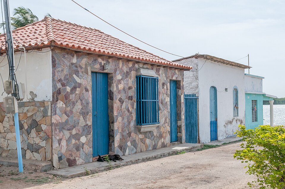 Blue doors and windows on a stone-clad house in Venezuela.