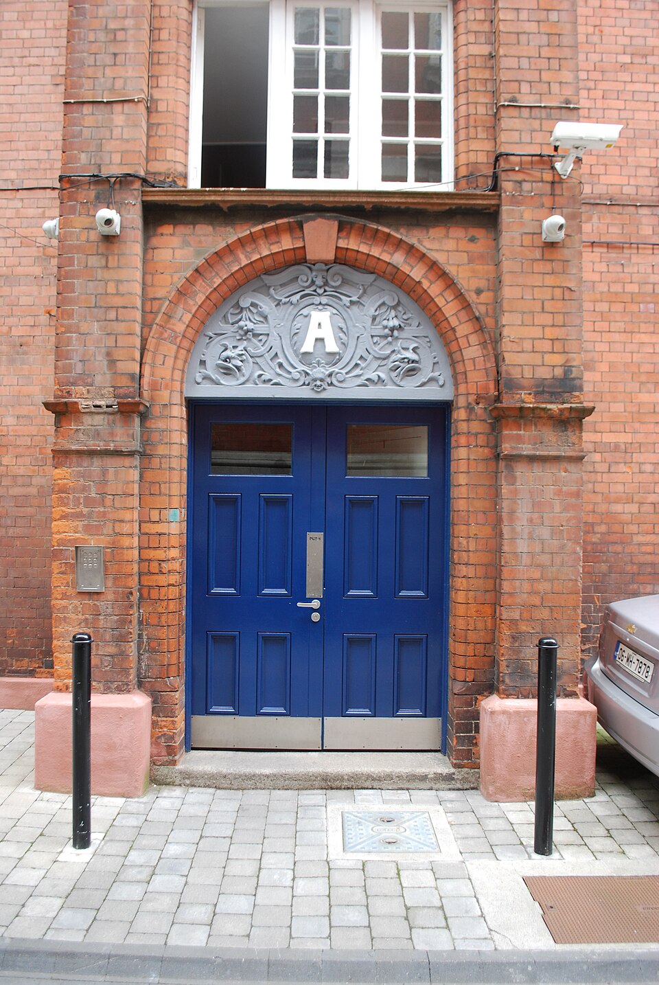 Blue double doors under a semicircular fanlight in Dublin.
